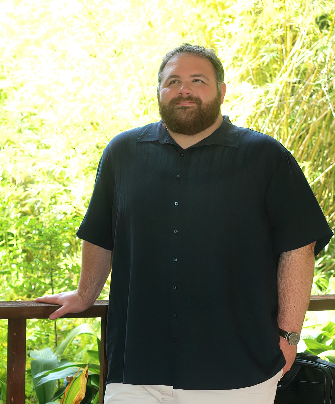 Kevin Lowe standing in a garden gazebo with one hand resting on the railing.